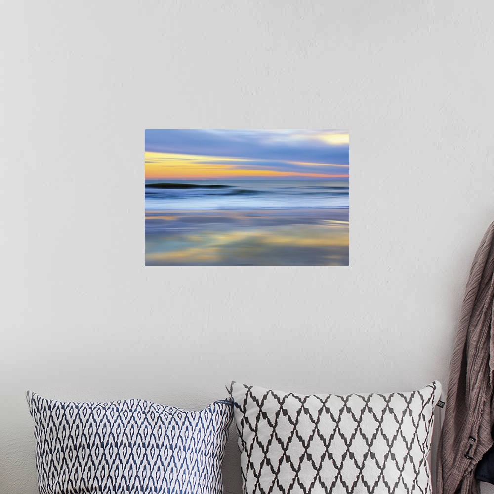 A bohemian room featuring Colorful photograph of a sunset over the ocean.