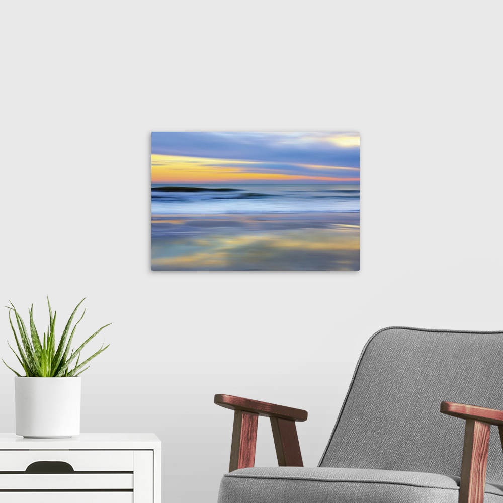A modern room featuring Colorful photograph of a sunset over the ocean.