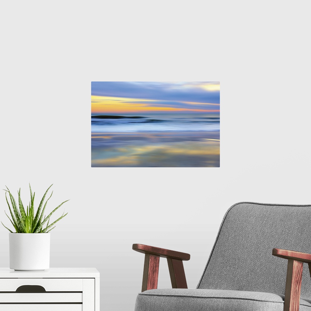 A modern room featuring Colorful photograph of a sunset over the ocean.
