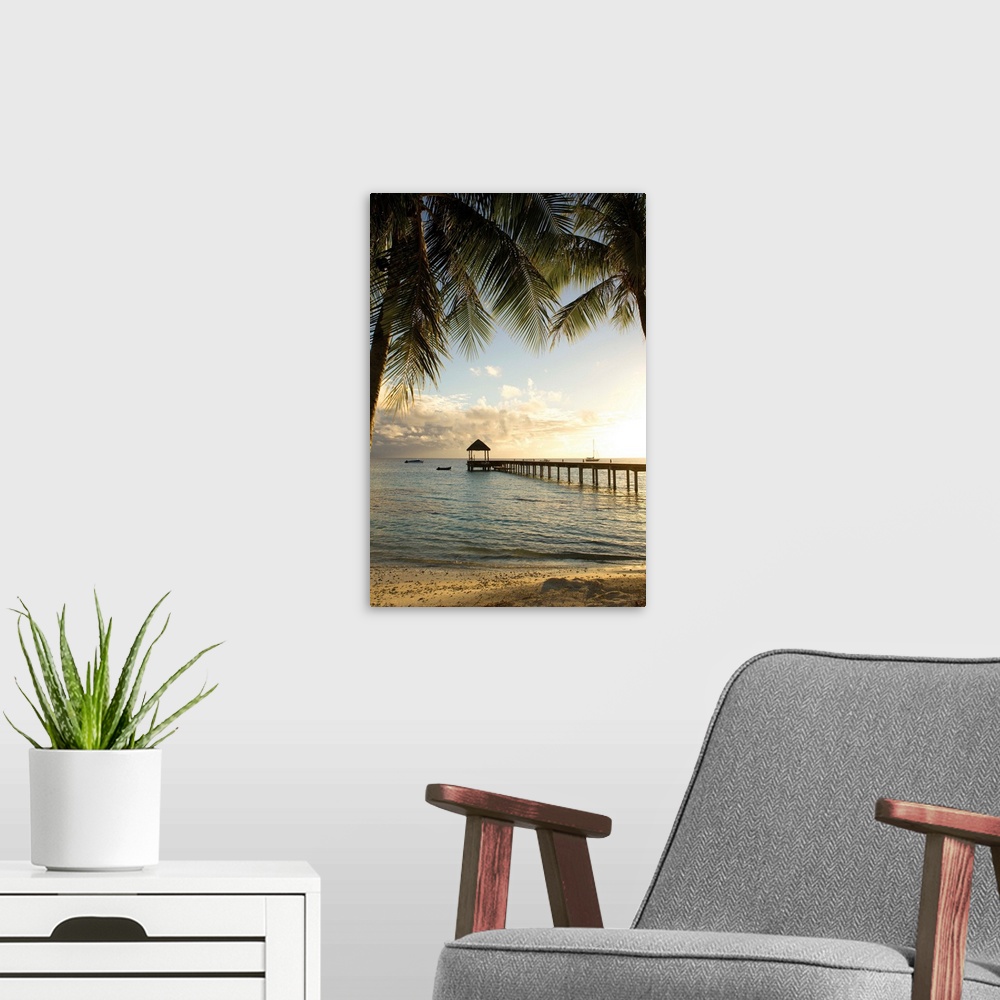 A modern room featuring Vertical photograph of a tropical landscape framed with palm trees on both sides and a long pier ...