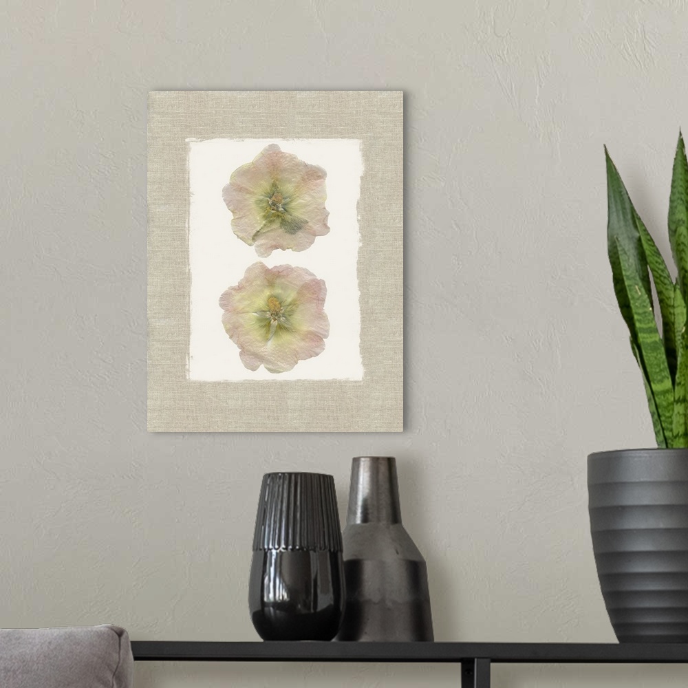 A modern room featuring Decor with two dried hollyhock flowers pressed onto a painted white square  with a burlap texture...