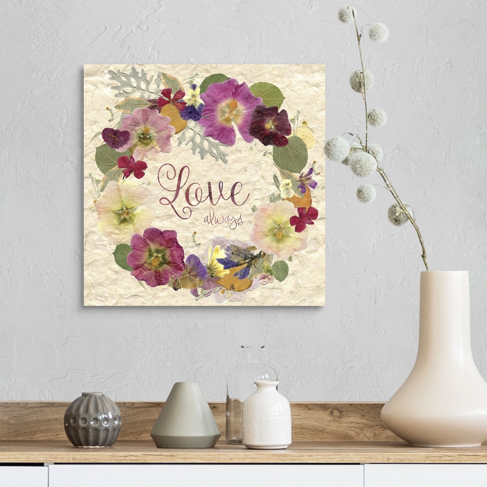 A farmhouse room featuring Square art with a wreath made of dried and pressed flowers with the phrase "Love Always" written ...