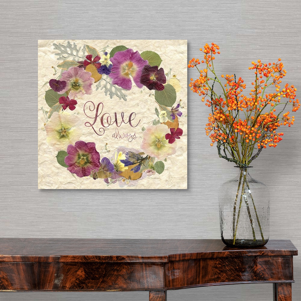 A traditional room featuring Square art with a wreath made of dried and pressed flowers with the phrase "Love Always" written ...