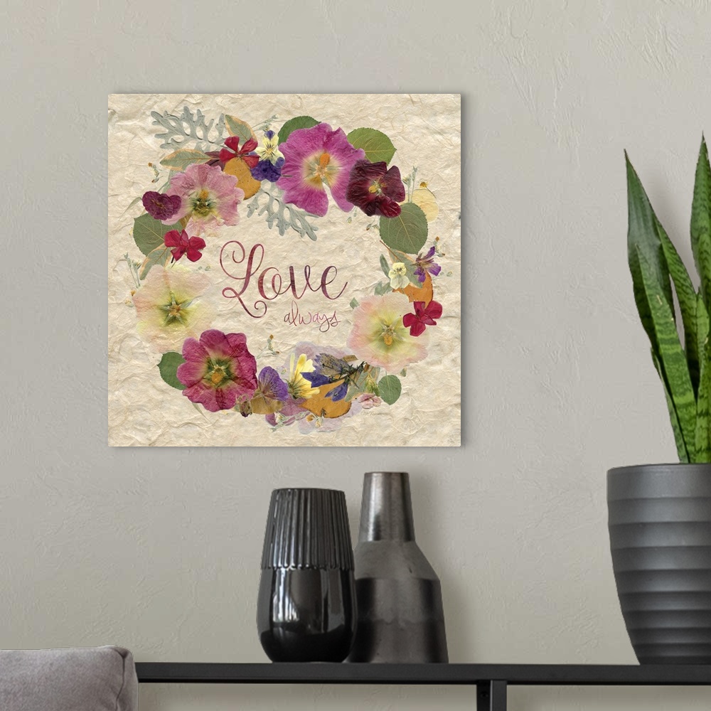 A modern room featuring The word "love" in a wreath made of dried, pressed flowers.