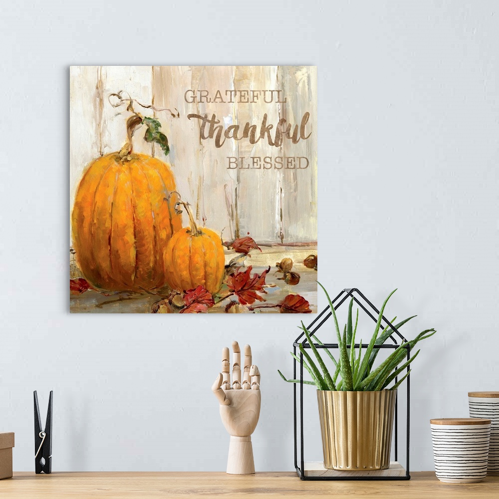 A bohemian room featuring "Grateful, Thankful, Blessed" written on a square canvas with illustrated pumpkins, acorns, and F...