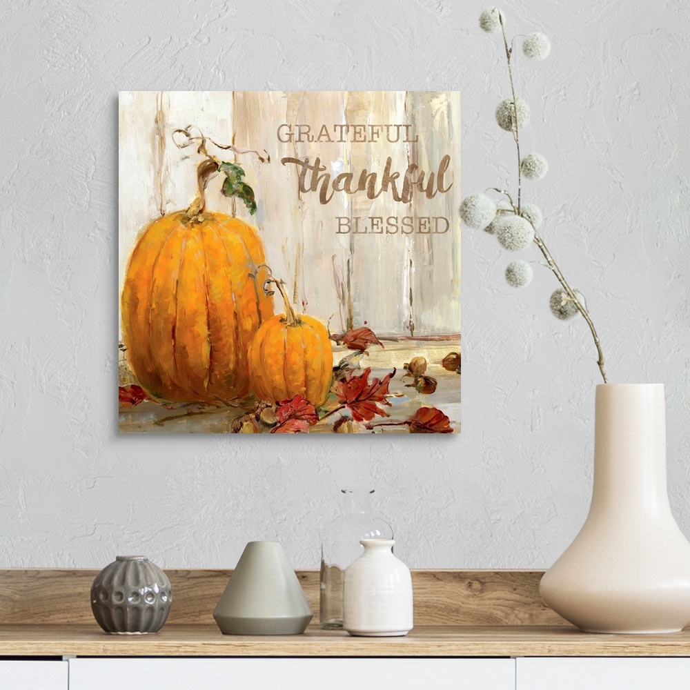 A farmhouse room featuring "Grateful, Thankful, Blessed" written on a square canvas with illustrated pumpkins, acorns, and F...