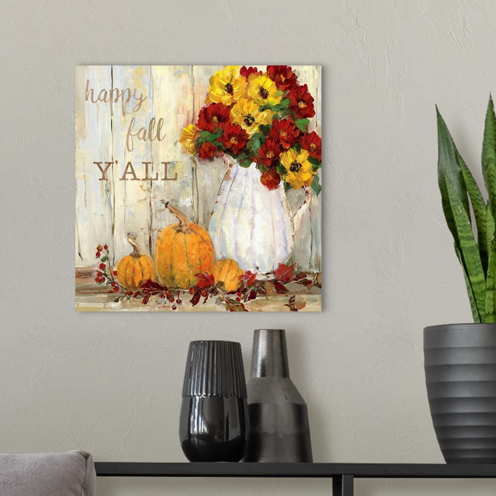 A modern room featuring "Happy Fall Y'all" written on a square canvas with illustrated pumpkins, flowers, acorns, and Fal...