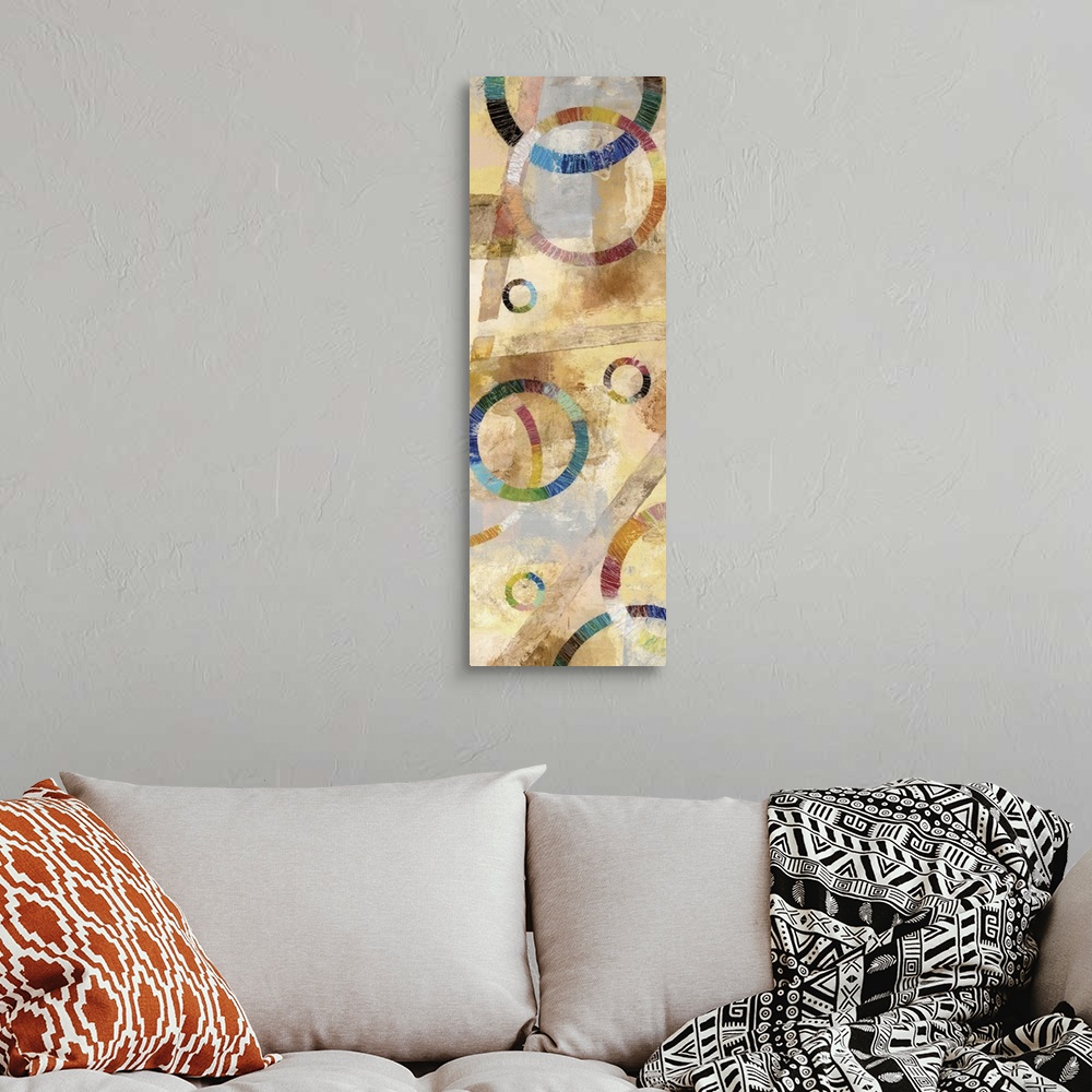 A bohemian room featuring Large abstract painting created with rainbow circles and a background filled with neutral colors.