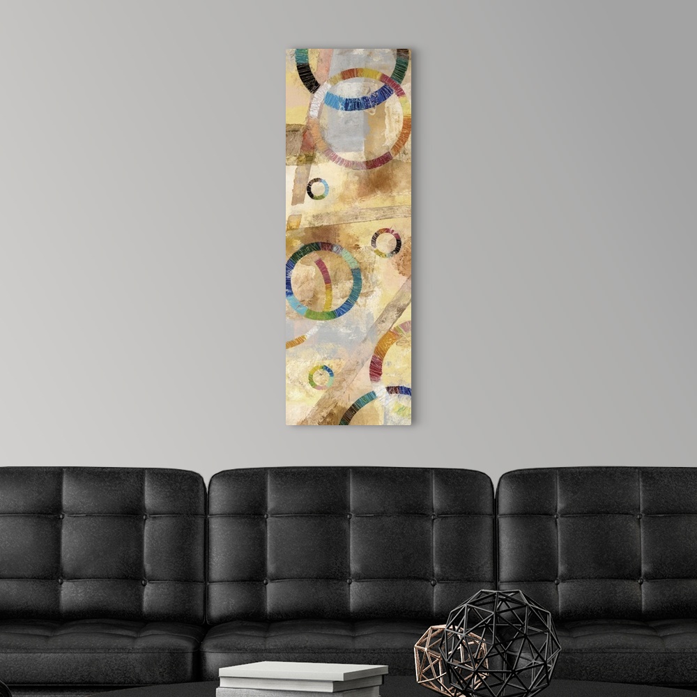 A modern room featuring Large abstract painting created with rainbow circles and a background filled with neutral colors.
