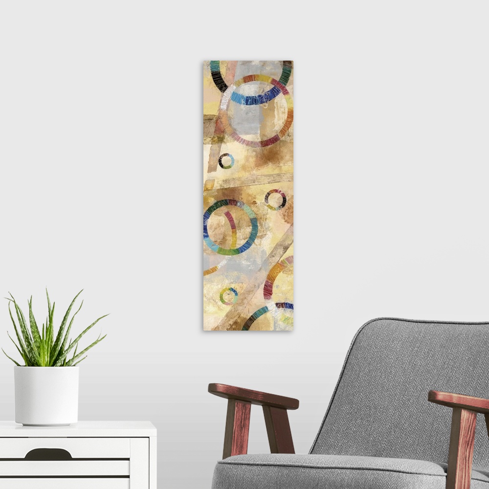 A modern room featuring Large abstract painting created with rainbow circles and a background filled with neutral colors.