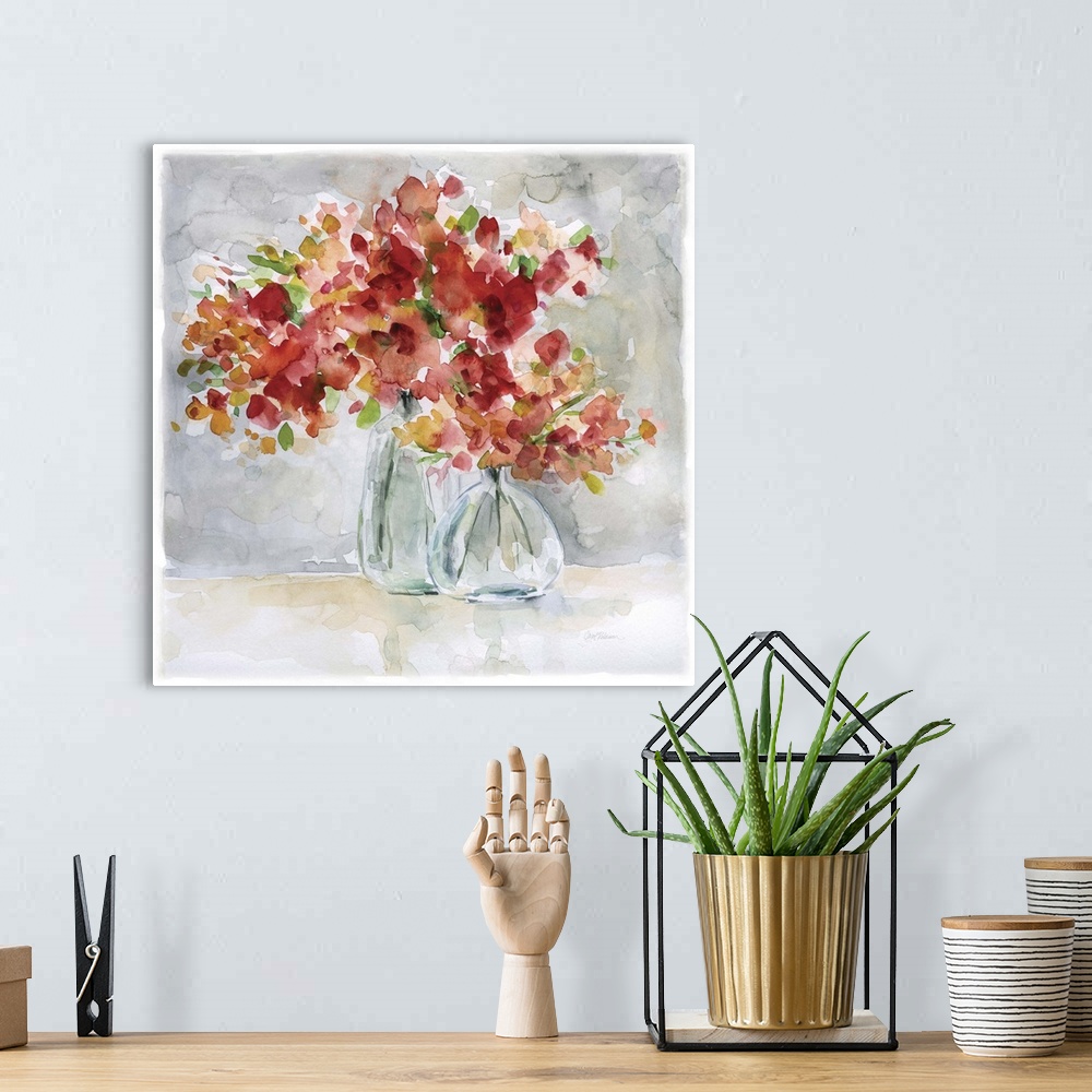A bohemian room featuring Beautiful square watercolor painting of red and orange flowers in glass vases on a gray and tan b...