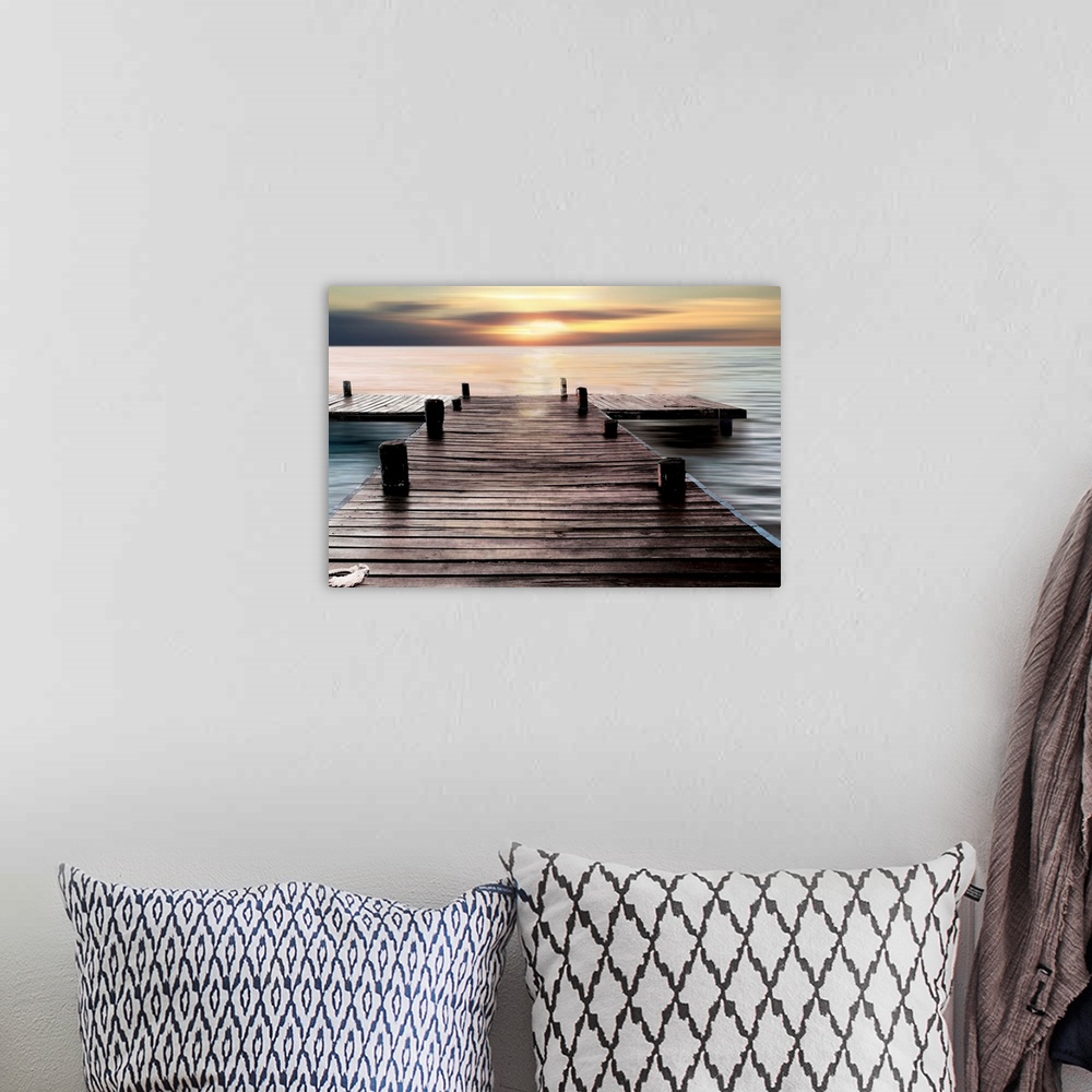 A bohemian room featuring A photo of a dock with the sky and water taken with a long exposure.