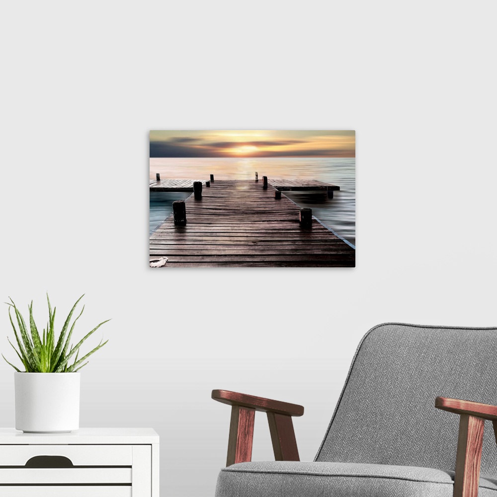 A modern room featuring A photo of a dock with the sky and water taken with a long exposure.