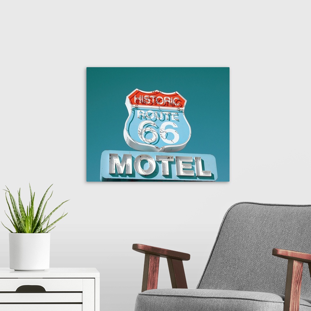 A modern room featuring Photograph of an antique Route 66 Motel sign on a clear blue sky background.