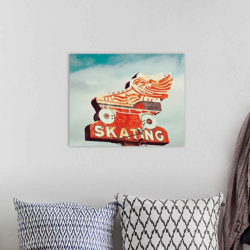 A bohemian room featuring Photograph of a vintage orange roller skating sign on a cloudy sky background.
