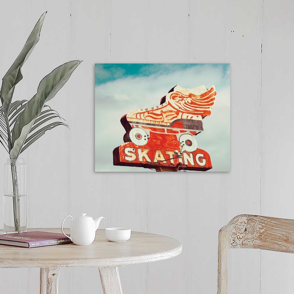 A farmhouse room featuring Photograph of a vintage orange roller skating sign on a cloudy sky background.