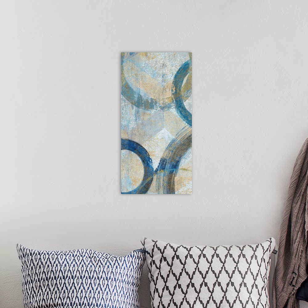 A bohemian room featuring Abstract painting that has big blue circular outlines with hints of gold on a textured background.