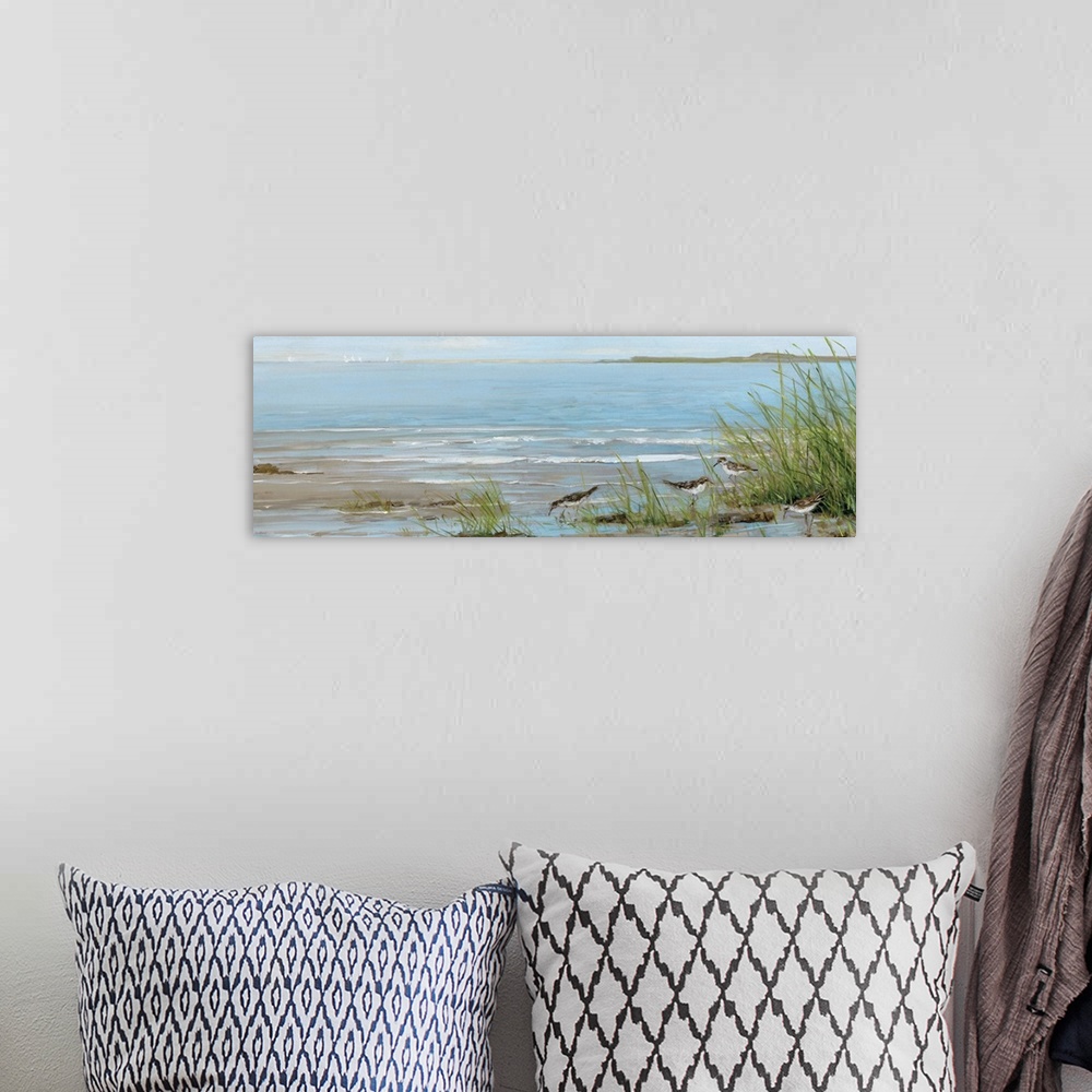 A bohemian room featuring A contemporary painting of a beach scene with birds foraging in the foreground and sailboats in t...