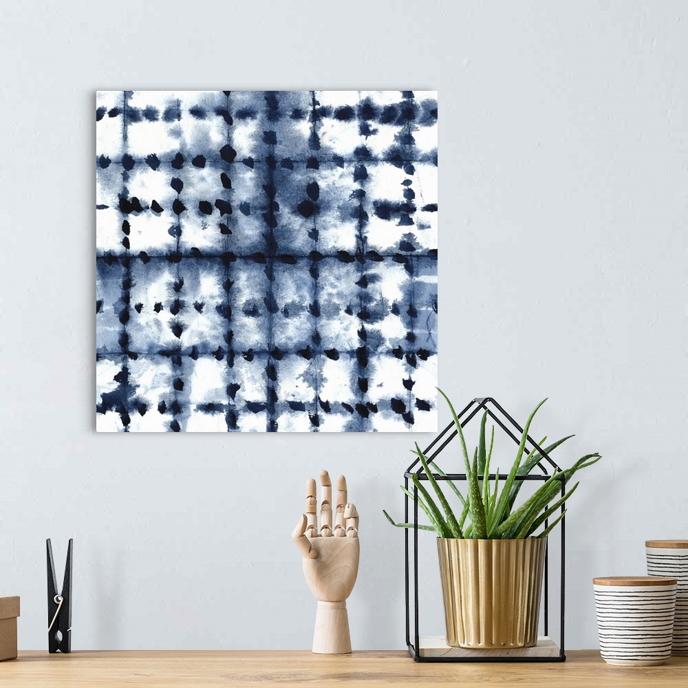 A bohemian room featuring Square shibori art with a pattern in indigo and white.