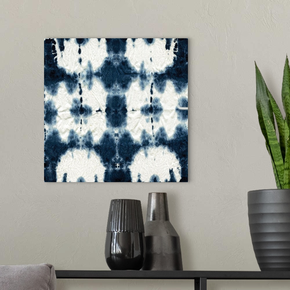 A modern room featuring Square shibori art with a pattern in indigo and white.