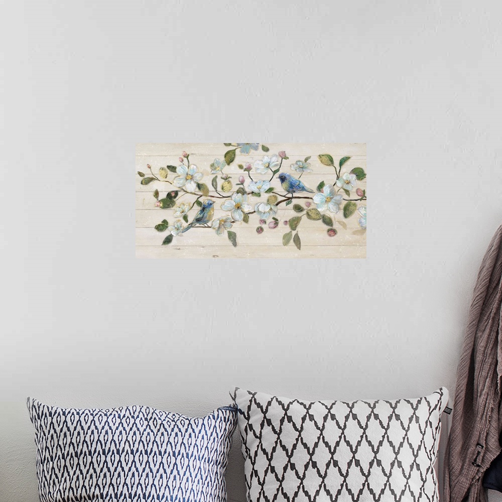 A bohemian room featuring A painting of two birds sitting on a branch surrounded by white flowers on a shiplap background.