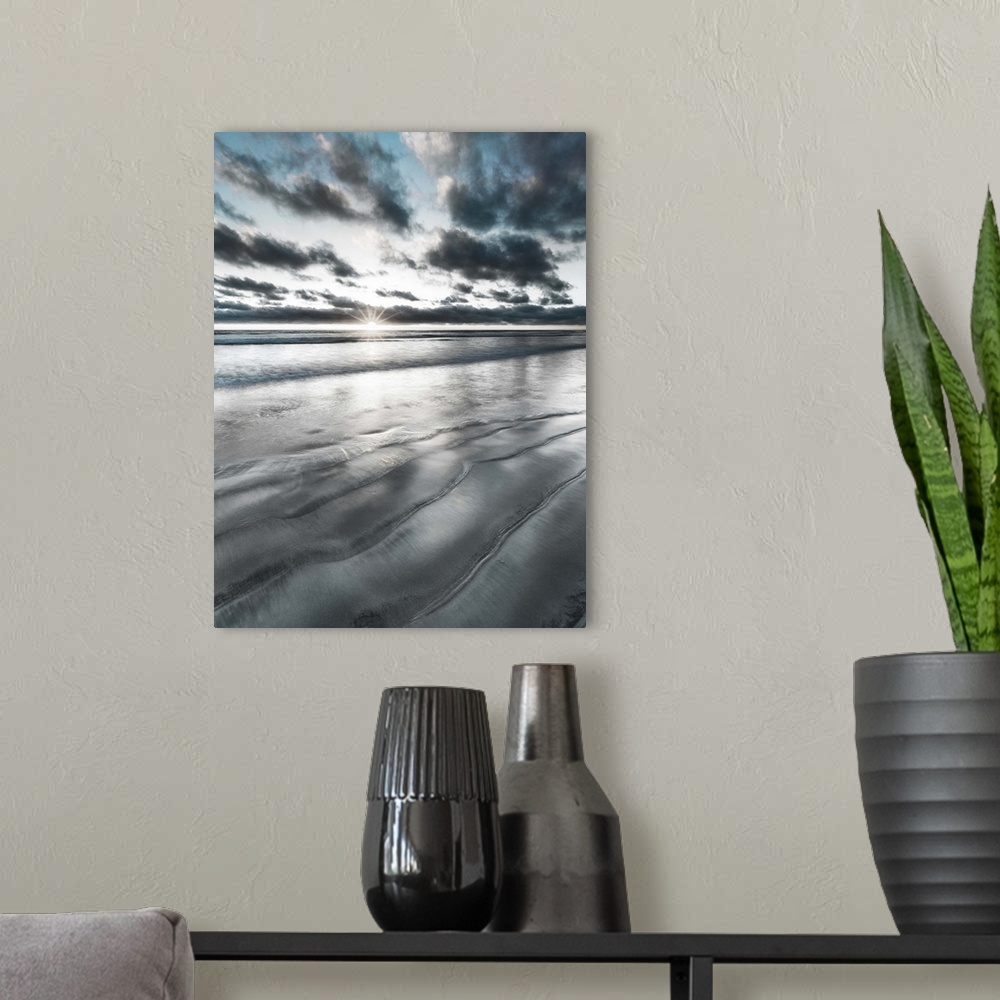 A modern room featuring Black, blue, and white manipulated photograph of a seascape with the sun right on the horizon line.