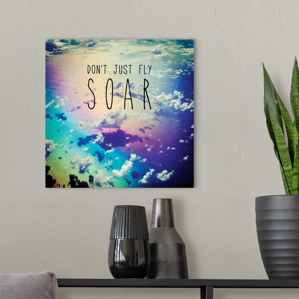 A modern room featuring Square photograph of clouds from a bird's eye view with a rainbow filter and the phrase "Don't Ju...