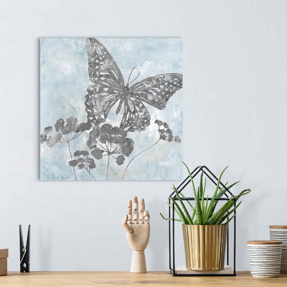 A bohemian room featuring Contemporary square painting of silver silhouettes of a butterfly and flowers with a light blue a...