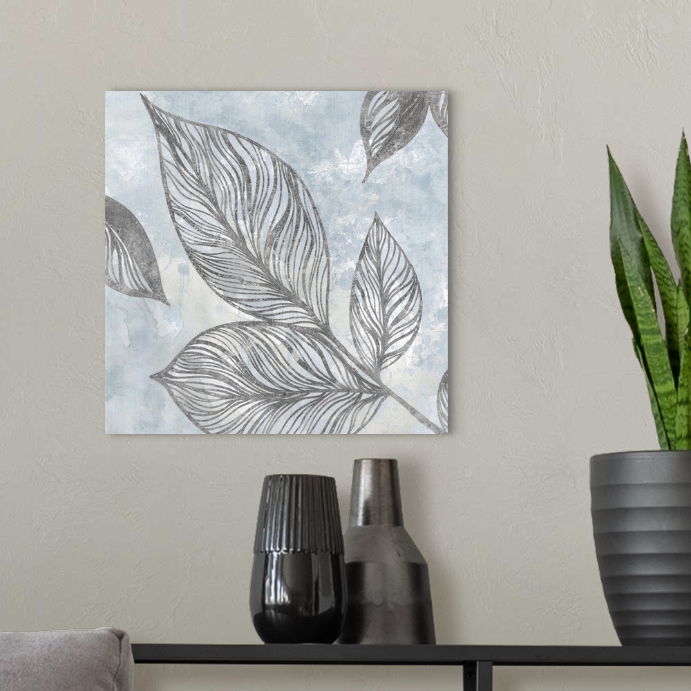 A modern room featuring Contemporary square painting of silver silhouettes of leaves with a light blue and white background.