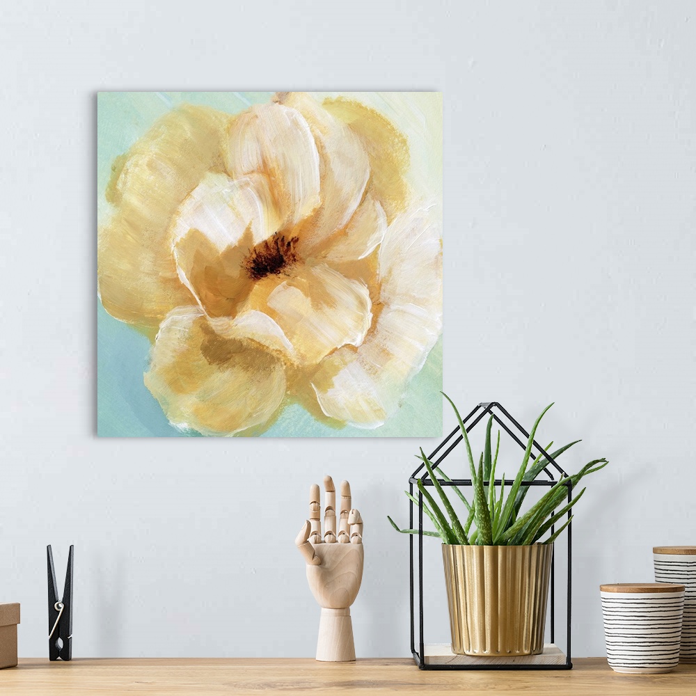 A bohemian room featuring Square painting of a yellow flower with cream highlights on a light blue and green background.