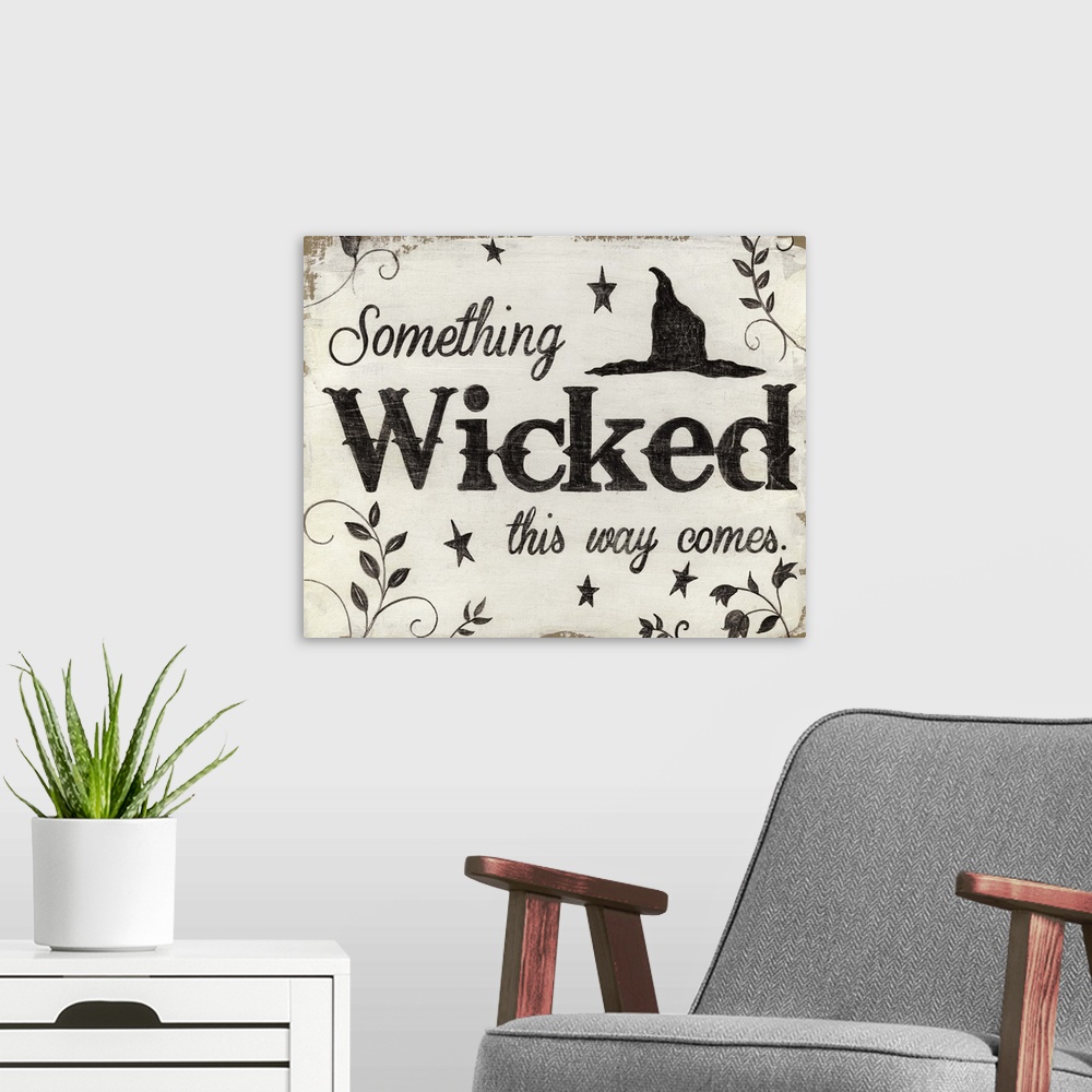 A modern room featuring A decorative Halloween painting that reads ?Something Wicked this way comes? on a white and tan b...