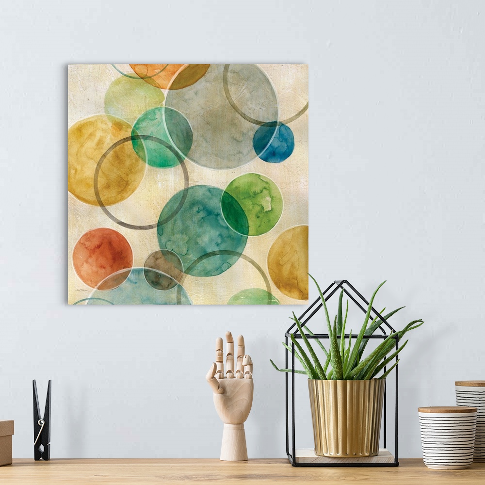A bohemian room featuring A contemporary abstract painting of various colored circles on canvas.