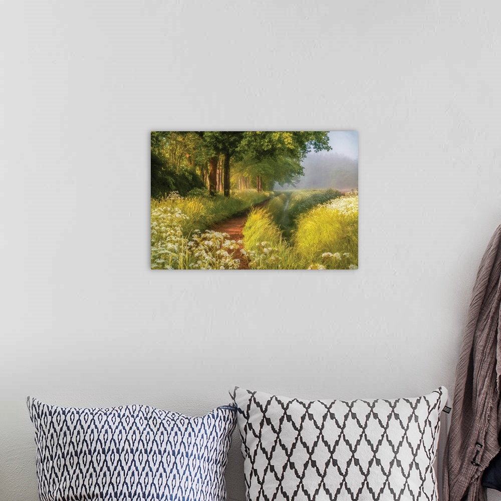 A bohemian room featuring A photo with a semblance of a painting displays a hidden pathway in a meadow during spring.