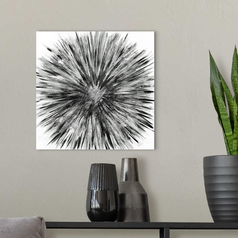 A modern room featuring Square abstract artwork of a black and grey sunburst design on a white background.