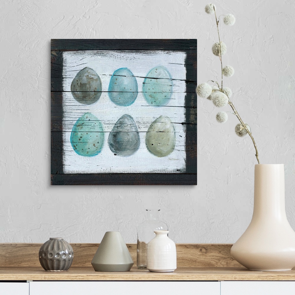 A farmhouse room featuring A wooden painting of six eggs using cool tones.