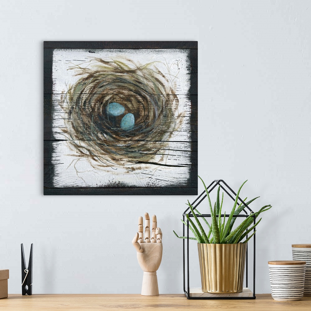 A bohemian room featuring A wooden painting of a bird's nest with two eggs inside.
