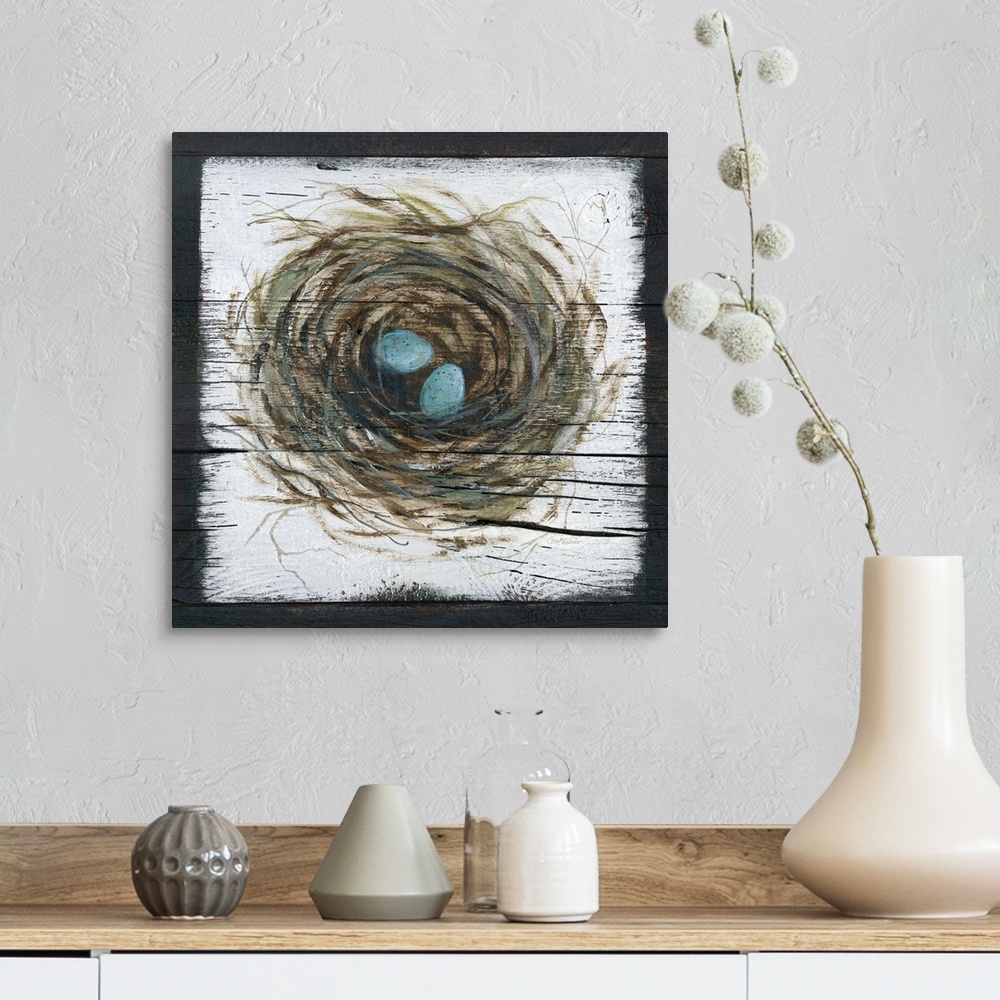 A farmhouse room featuring A wooden painting of a bird's nest with two eggs inside.