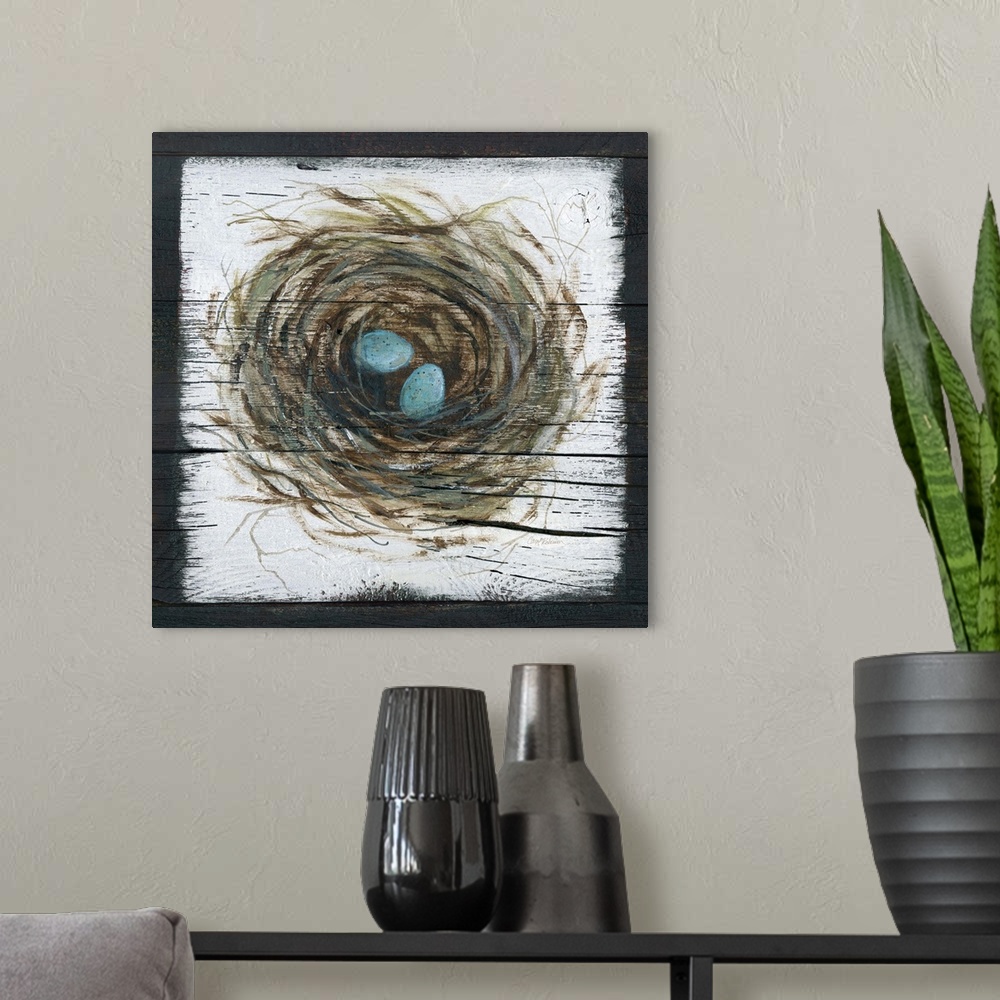 A modern room featuring A wooden painting of a bird's nest with two eggs inside.