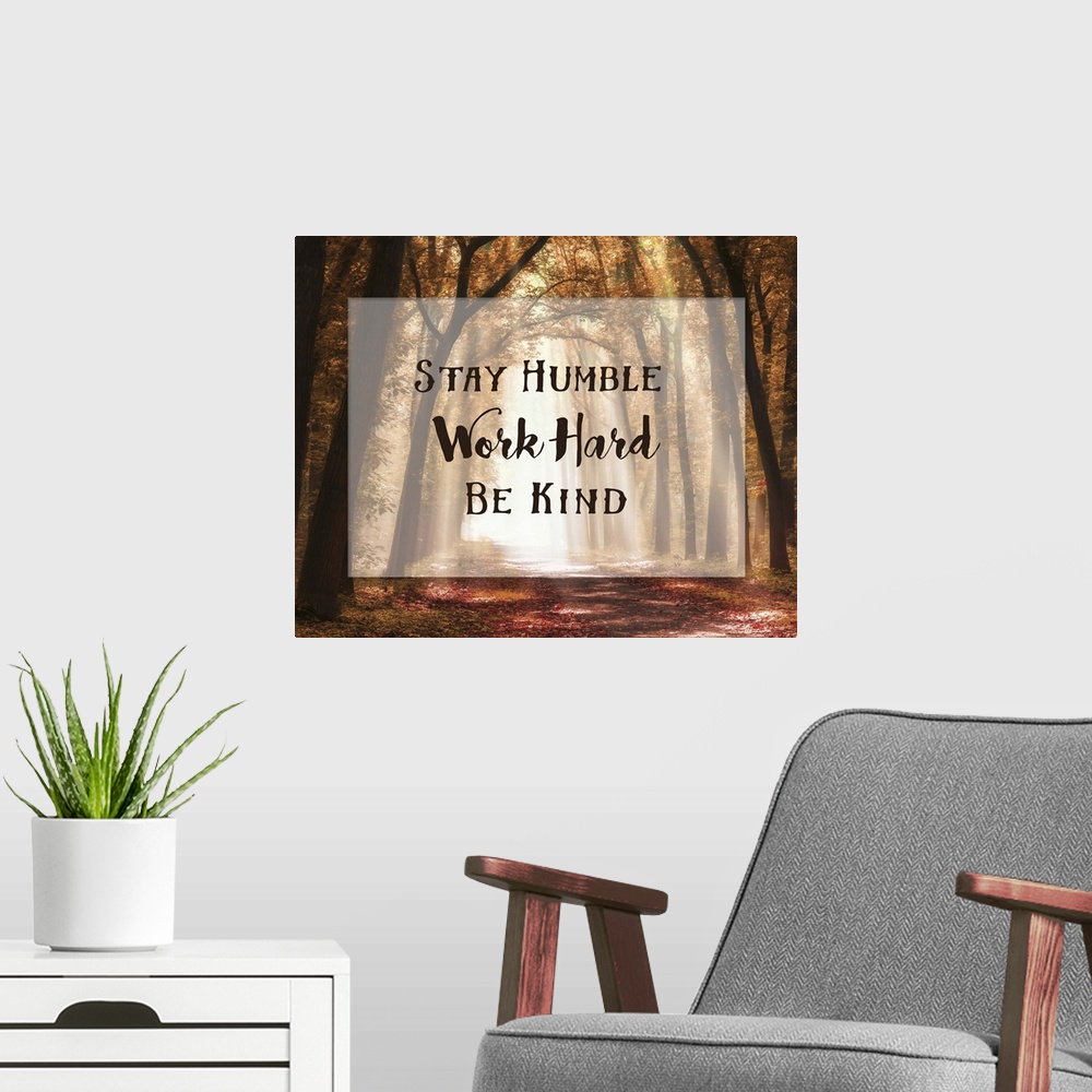 A modern room featuring A photograph of a pathway in the autumn woods with an inspirational quote overlay.
