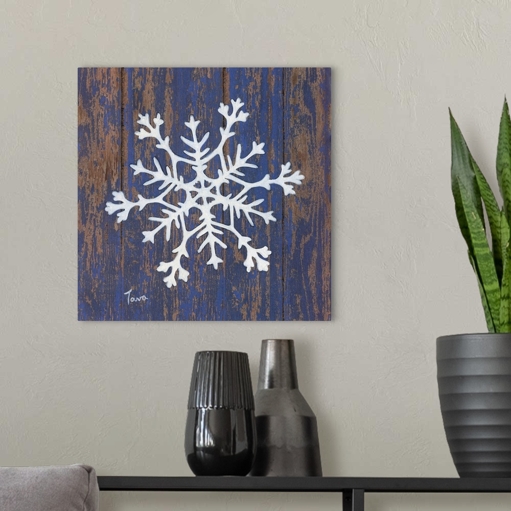 A modern room featuring A decorative painting of a white snowflake on a blue, aged wooden background.