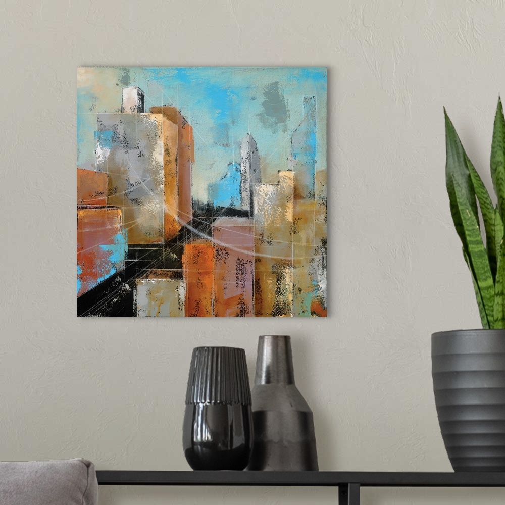 A modern room featuring Square abstract painting of a streetscape using red, orange, yellow, and blue hues.
