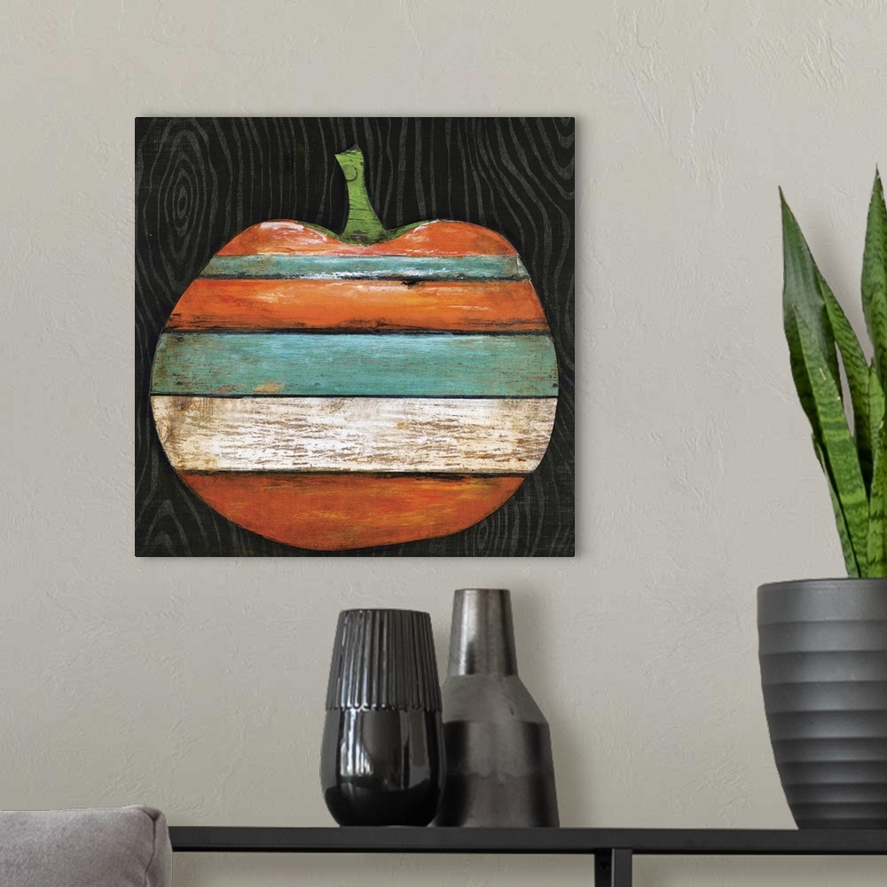 A modern room featuring A wood painting of an orange, teal, black, and white striped pumpkin on a black background.
