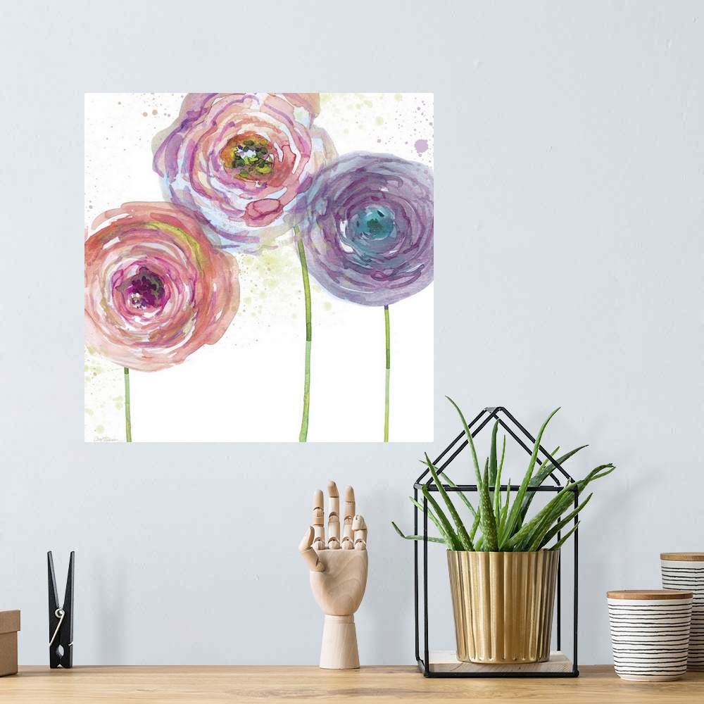 A bohemian room featuring A watercolor painting of three pink, purple, and blue toned flowers.