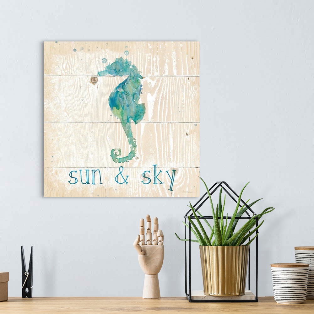A bohemian room featuring A beach themed watercolor on a wooden background.