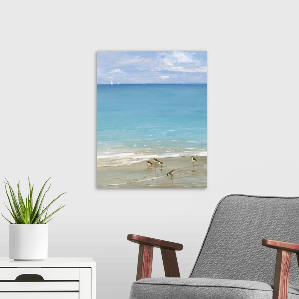A modern room featuring Contemporary painting of the seashore with seabirds in the foreground and two sailboats in the di...