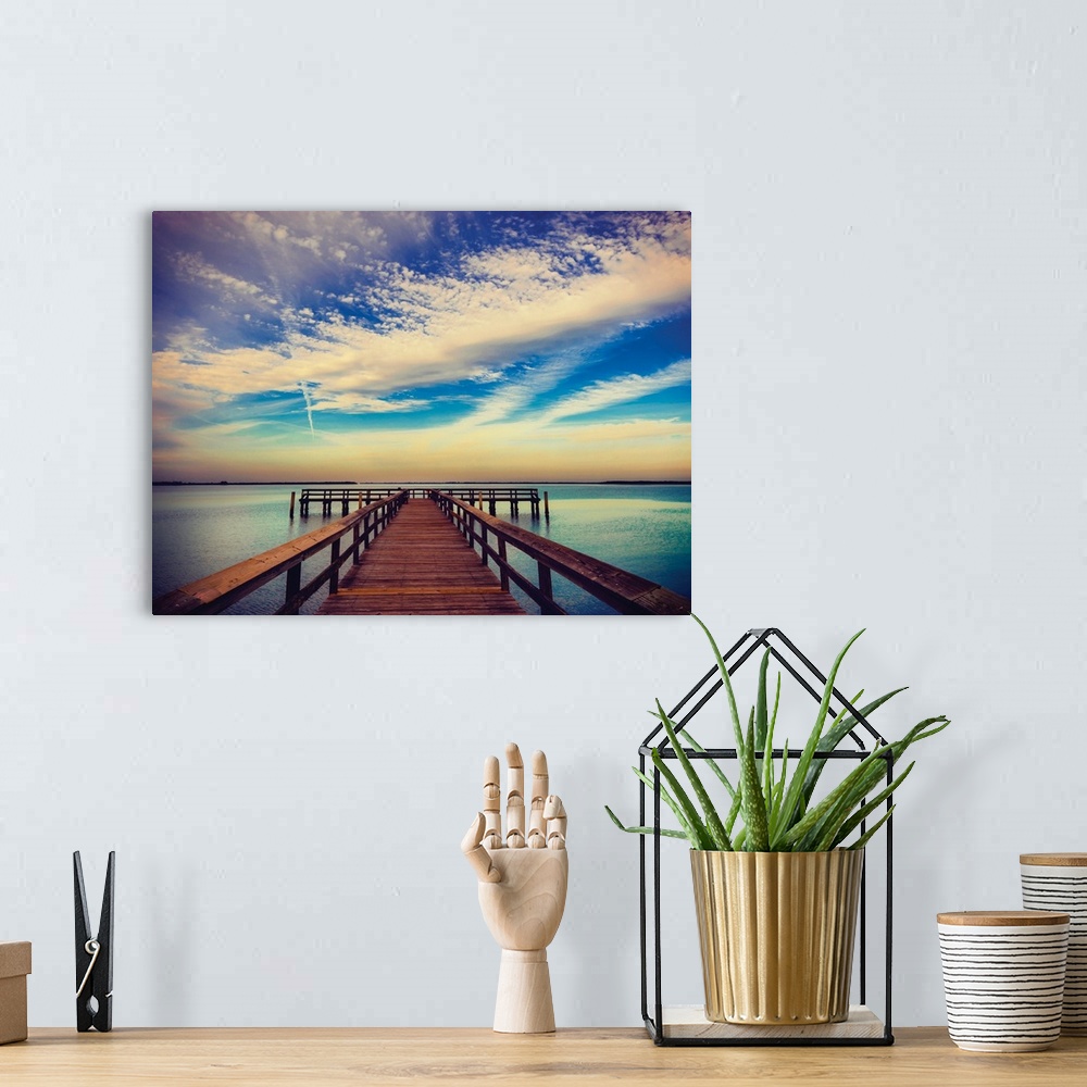 A bohemian room featuring Photograph of a pier at sunrise with beautiful clouds.