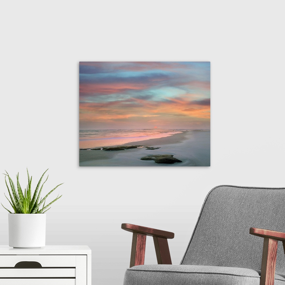 A modern room featuring Landscape photograph of a colorful sunset on Matanzas Beach, FL.