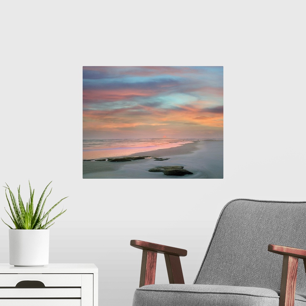A modern room featuring Landscape photograph of a colorful sunset on Matanzas Beach, FL.