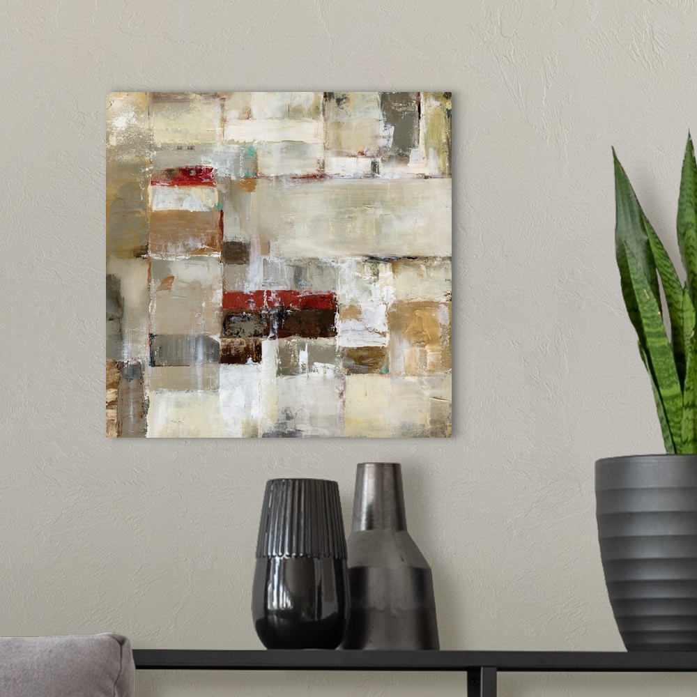 A modern room featuring A square abstract painting in natural shades of brown, beige and red.