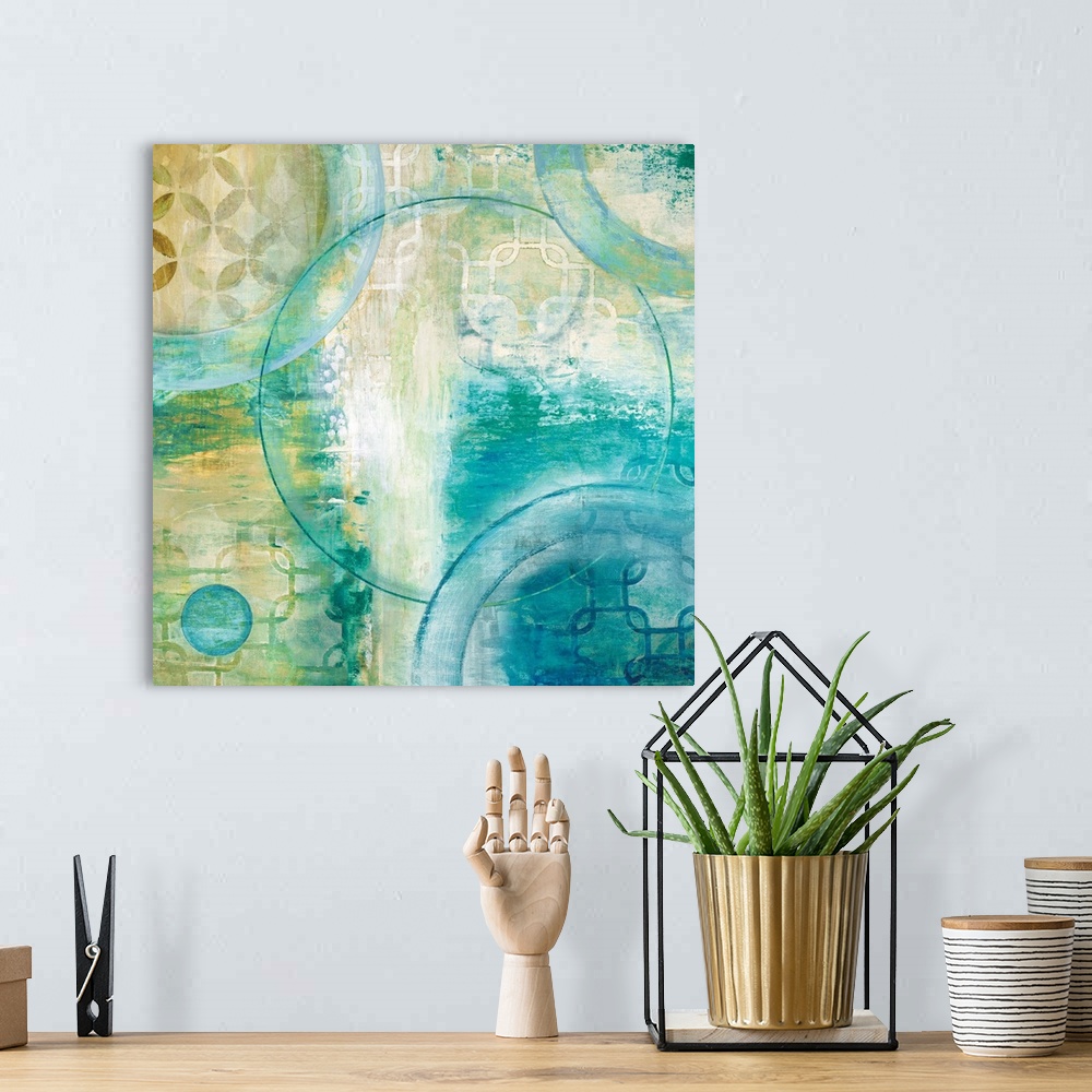 A bohemian room featuring Square abstract painting using different shapes with teal and yellow hues.